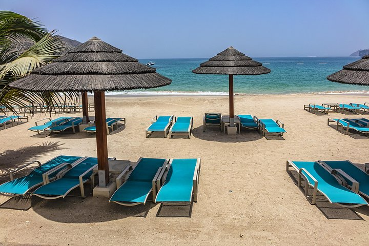 Relax on soft sands under shaded palms while waves lap gently at your feet. Khor Fakkan Beach invites families to explore its vibrant marine life and stunning coral reefs.